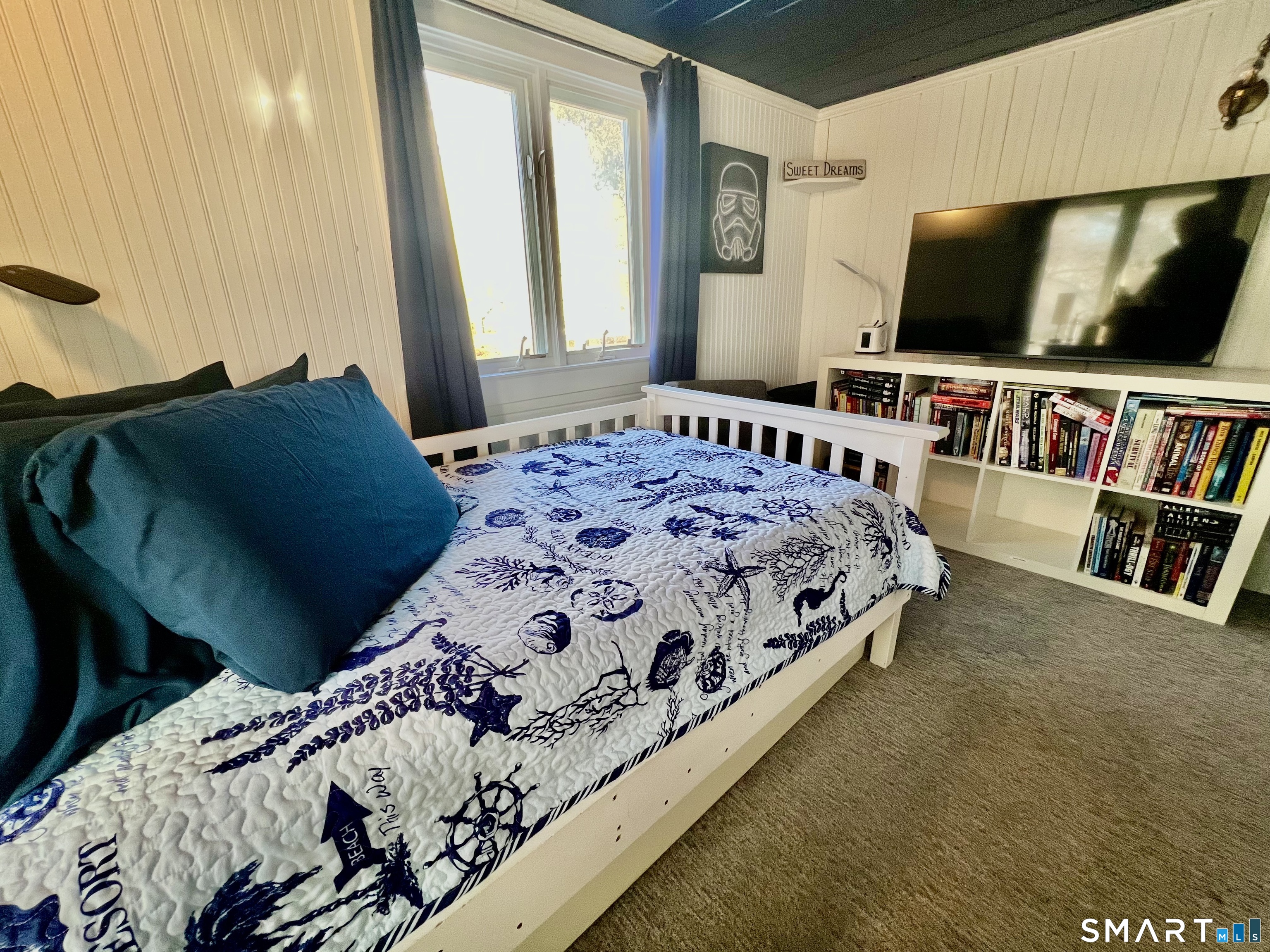 624 Vineyard Point Road Guilford, CT 06437 - Photo 24 of 40 a bedroom with a bed and a flat screen tv