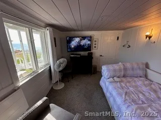 a bedroom with furniture and a window