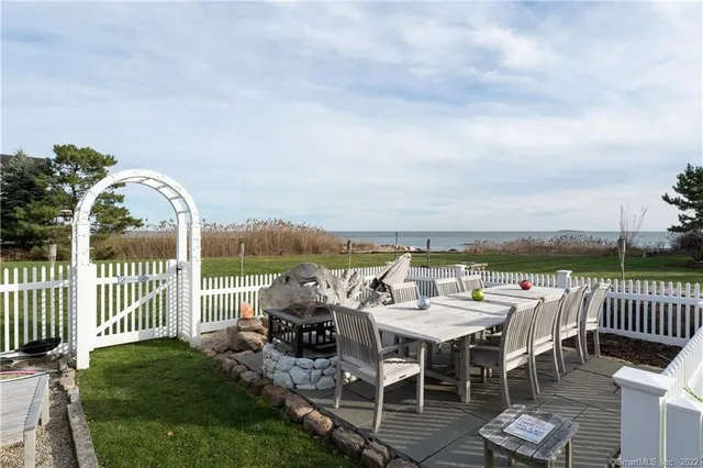 a view of a house with pool and sitting area