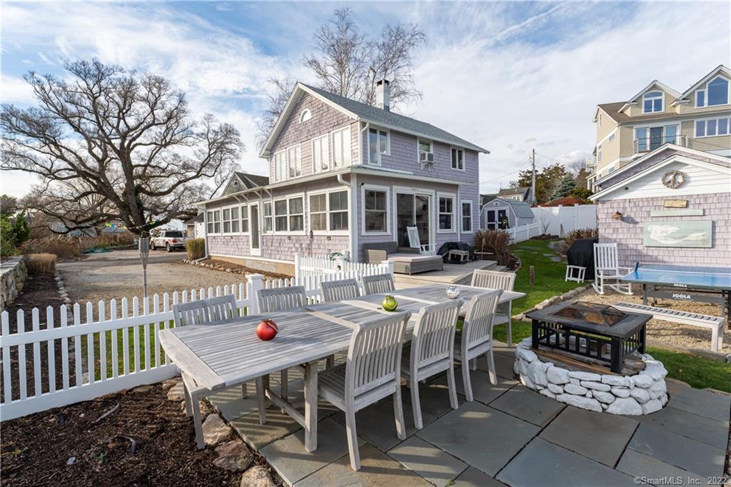 624 Vineyard Point Road Guilford, CT 06437 - Photo 31 of 40 a view of a patio with a table and chairs