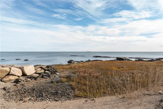 a view of a large house with a big yard and large trees
