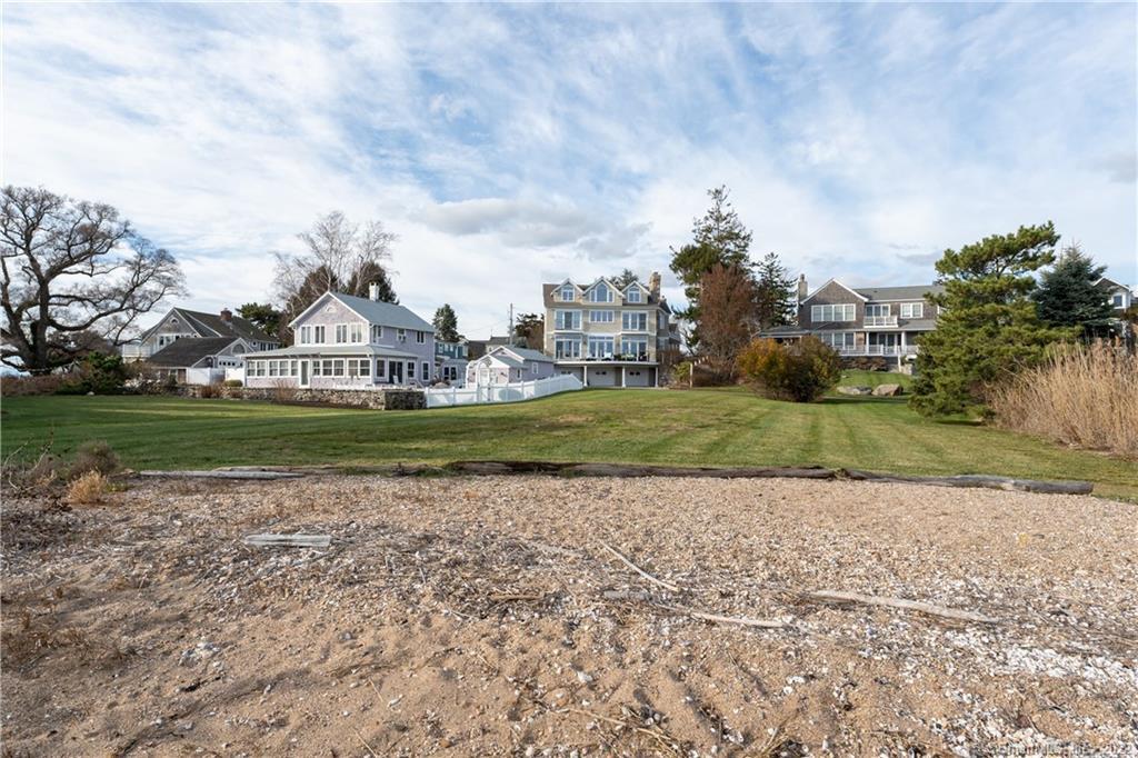 624 Vineyard Point Road Guilford, CT 06437 - Photo 4 of 38 a view of a house with a big yard and potted plants and large trees
