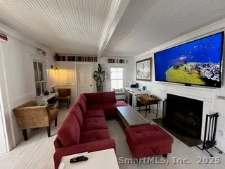 a living room with furniture a rug and a fireplace