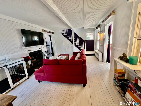 a living room with furniture and a flat screen tv