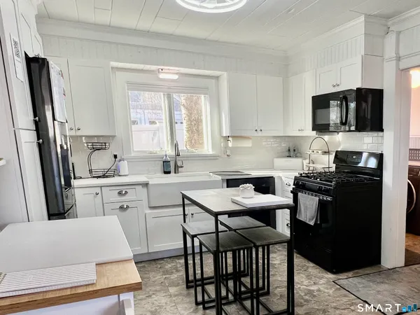a kitchen with stainless steel appliances a refrigerator stove microwave and sink