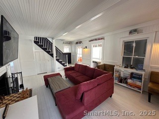 624 Vineyard Point Road Guilford, CT 06437 - Photo 7 of 38 a living room with furniture and a flat screen tv