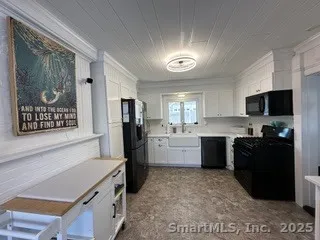 a kitchen with a refrigerator and a stove top oven