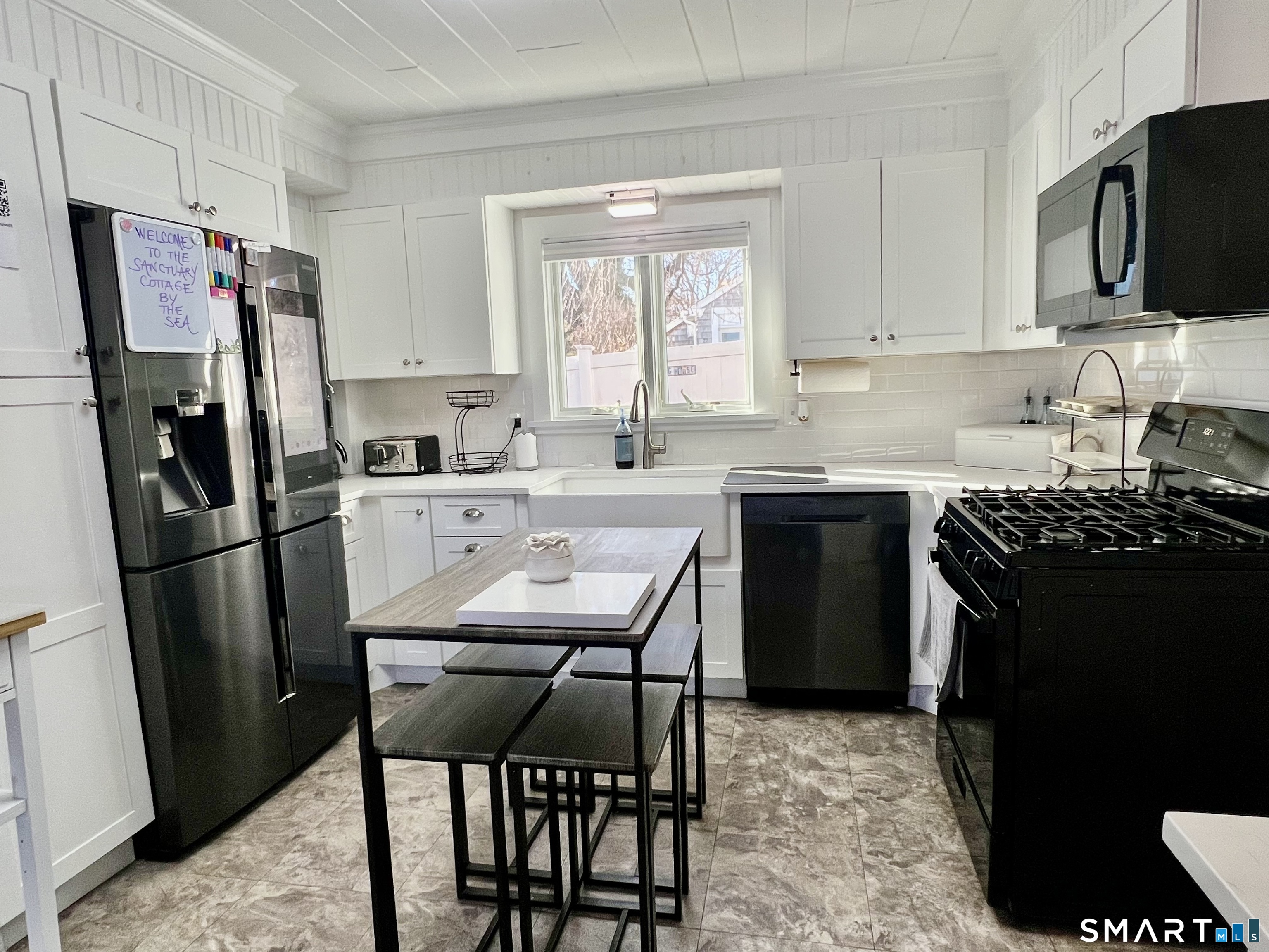 624 Vineyard Point Road Guilford, CT 06437 - Photo 9 of 40 a kitchen with stainless steel appliances a refrigerator stove microwave and sink