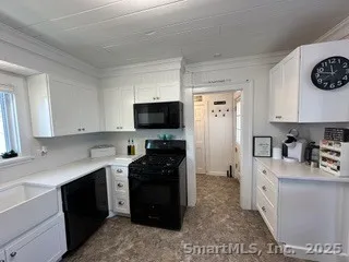 a kitchen with a refrigerator and a stove top oven