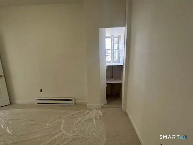 a view of an empty room and a window