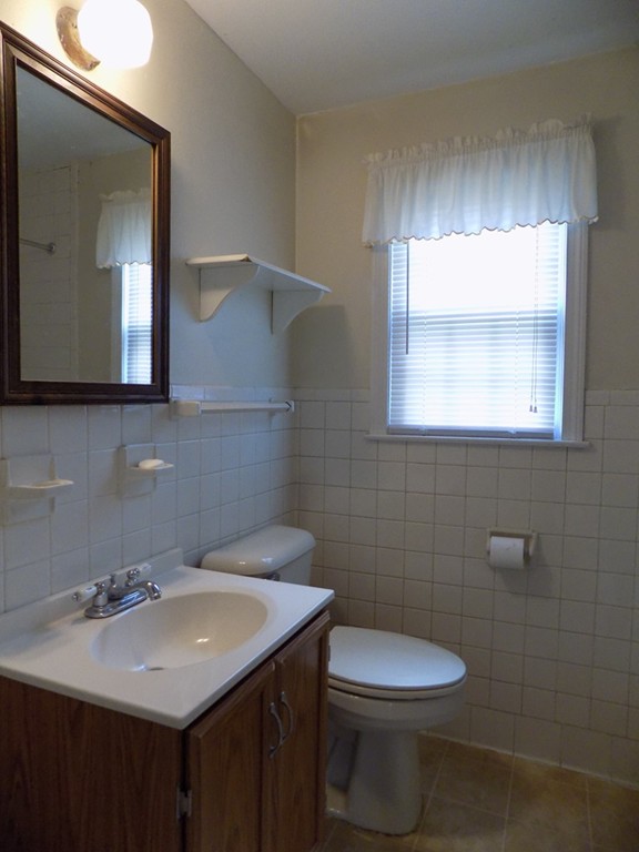 35 Burnside Terrace Springfield, MA 01118 - Photo 11 of 12 a bathroom with a sink a toilet and mirror