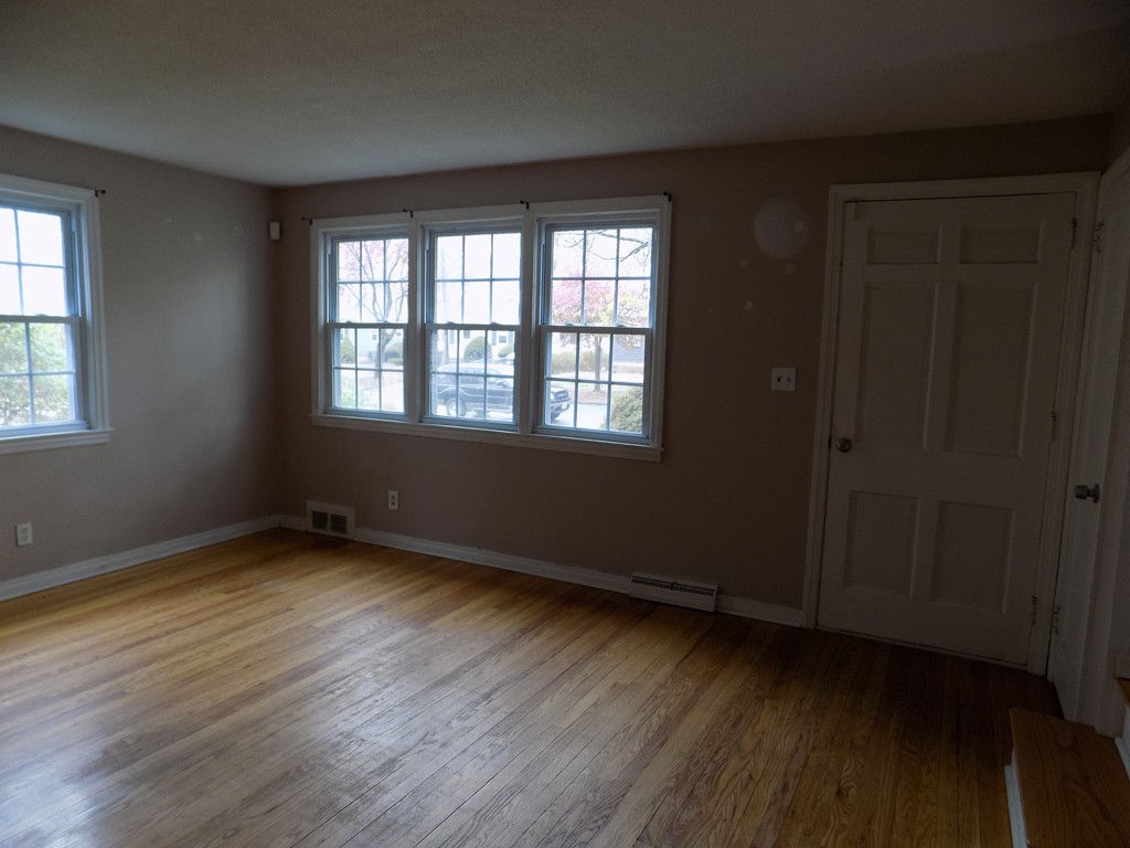 35 Burnside Terrace Springfield, MA 01118 - Photo 2 of 12 a view of an empty room with wooden floor and a window