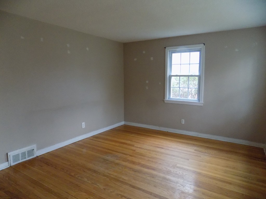 35 Burnside Terrace Springfield, MA 01118 - Photo 7 of 12 an empty room with wooden floor and windows