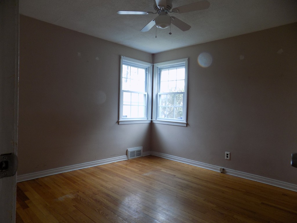 35 Burnside Terrace Springfield, MA 01118 - Photo 8 of 12 an empty room with wooden floor fan and windows