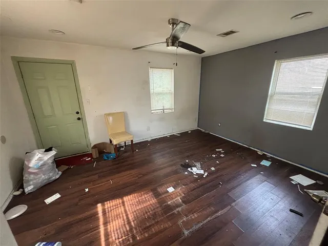 a bedroom with a bed window and a table