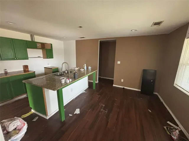 a kitchen with sink and mirror