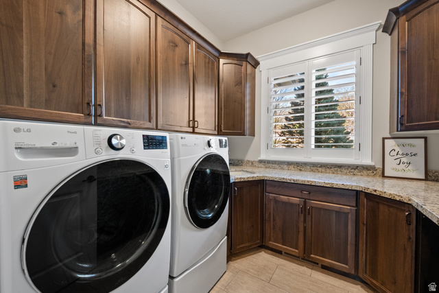 1205 North Elk Rdg Lane, Unit 202 Alpine, UT 84004 - Photo 24 of 88 Laundry area featuring wood-finish cabinetry, granite-style countertops, and a window with plantation shutters