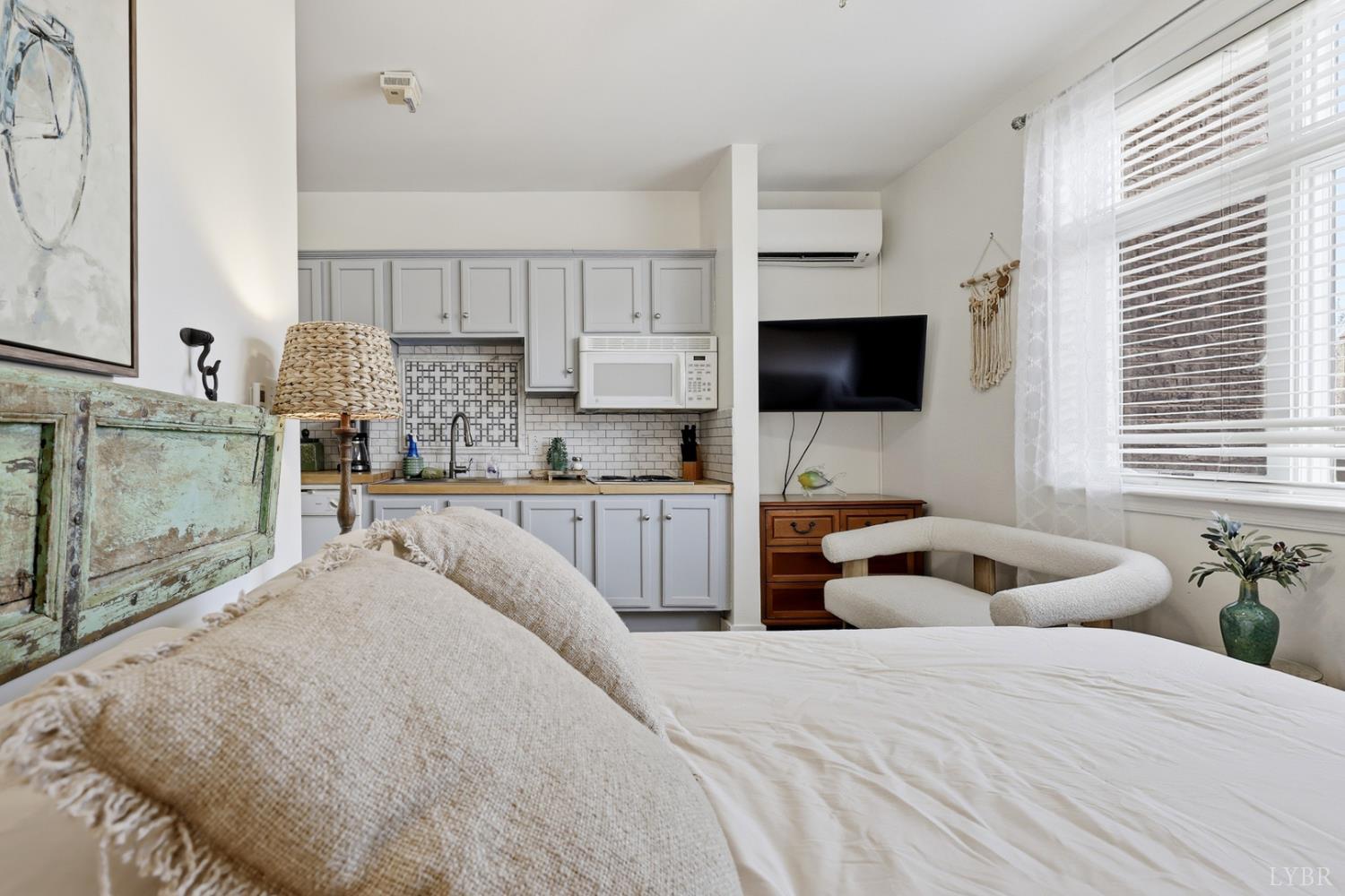 1245 Graves Harbor Trail, Unit 2101 Huddleston, VA 24104 - Photo 12 of 40 a bedroom with a bed and a flat screen tv