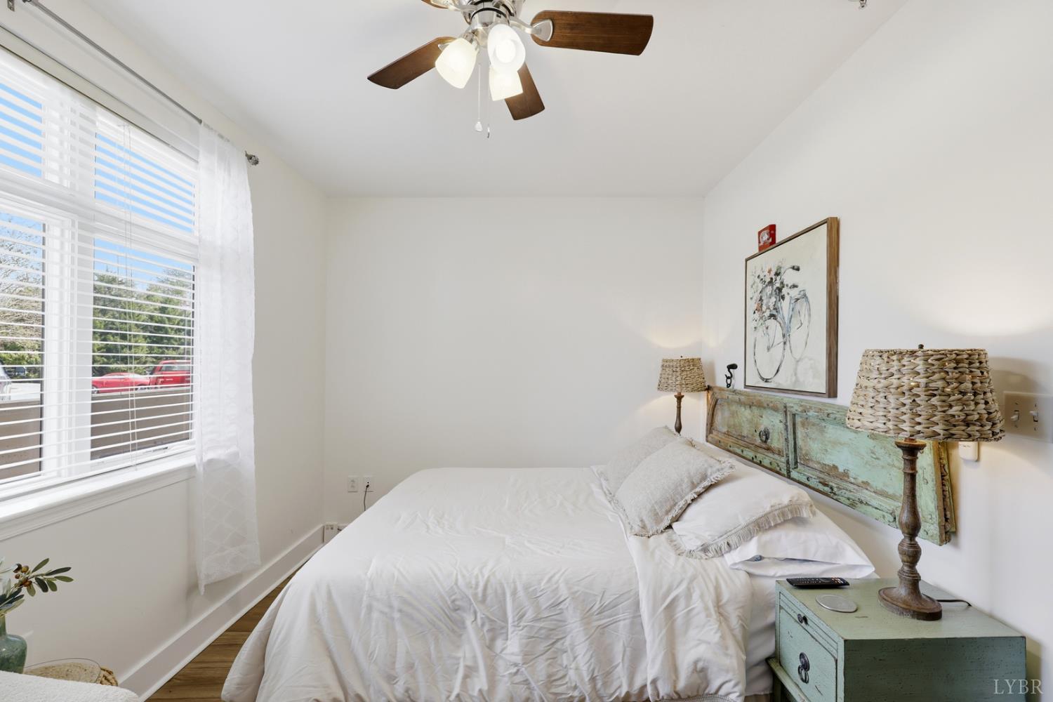 1245 Graves Harbor Trail, Unit 2101 Huddleston, VA 24104 - Photo 14 of 40 a bedroom with a bed and lamp on the dresser