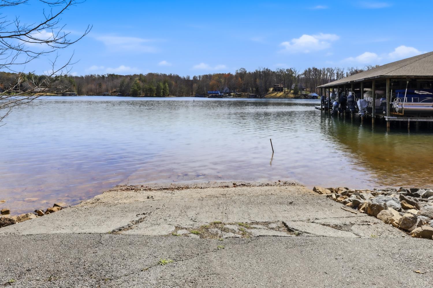 1245 Graves Harbor Trail, Unit 2101 Huddleston, VA 24104 - Photo 24 of 40 a view of a lake with a mountain in the background