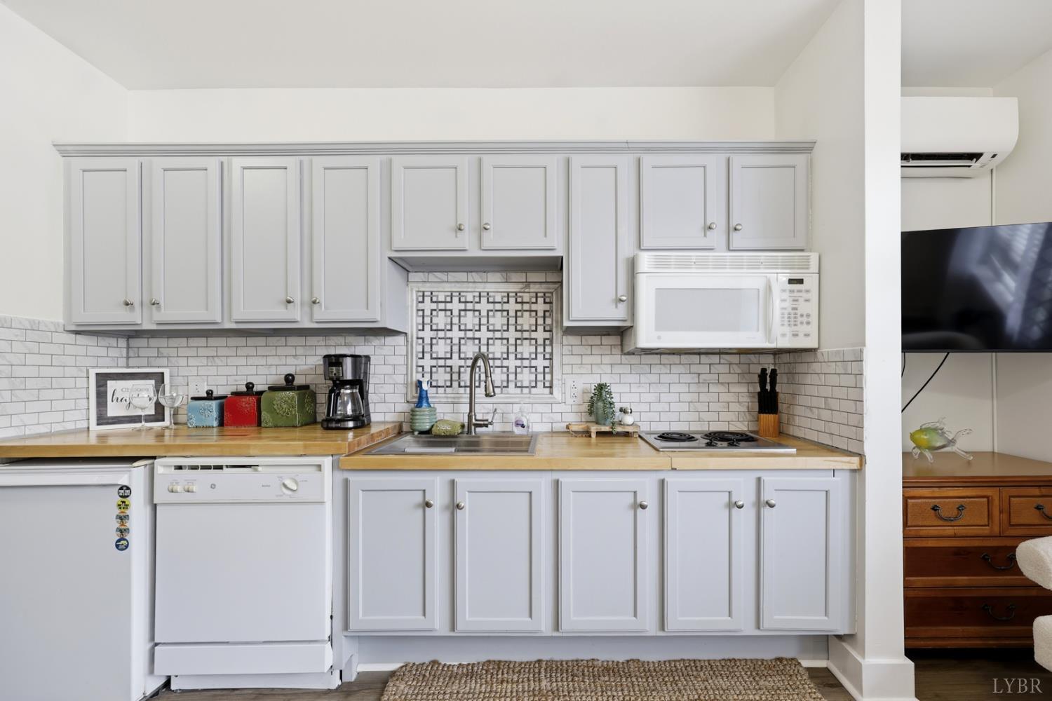 1245 Graves Harbor Trail, Unit 2101 Huddleston, VA 24104 - Photo 5 of 40 a kitchen with white cabinets and appliances