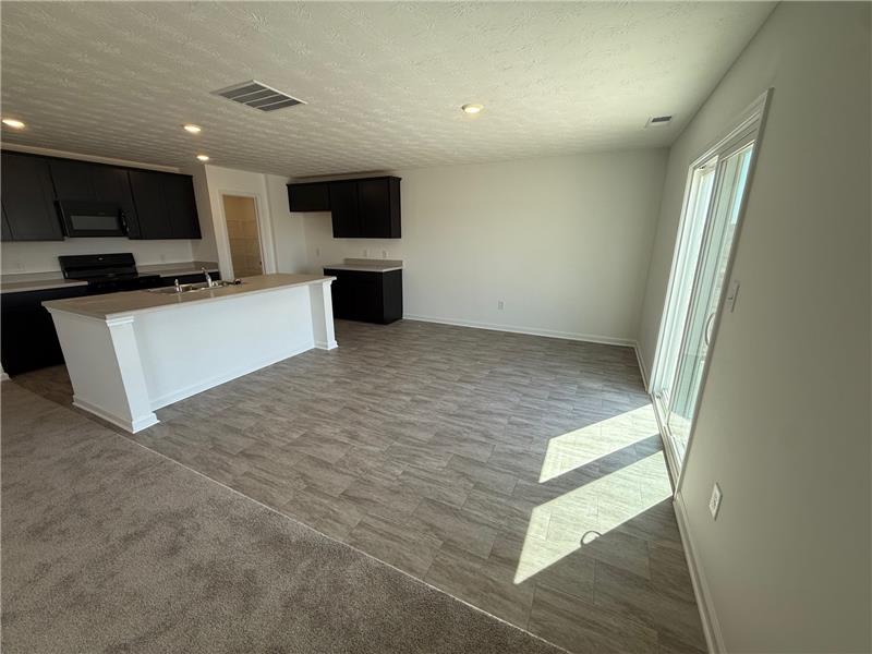 4005 Chakeres Avenue Springfield, OH 45505 - Photo 5 of 19 This bright, open concept living area seamlessly blends kitchen, dining, and outdoor access.