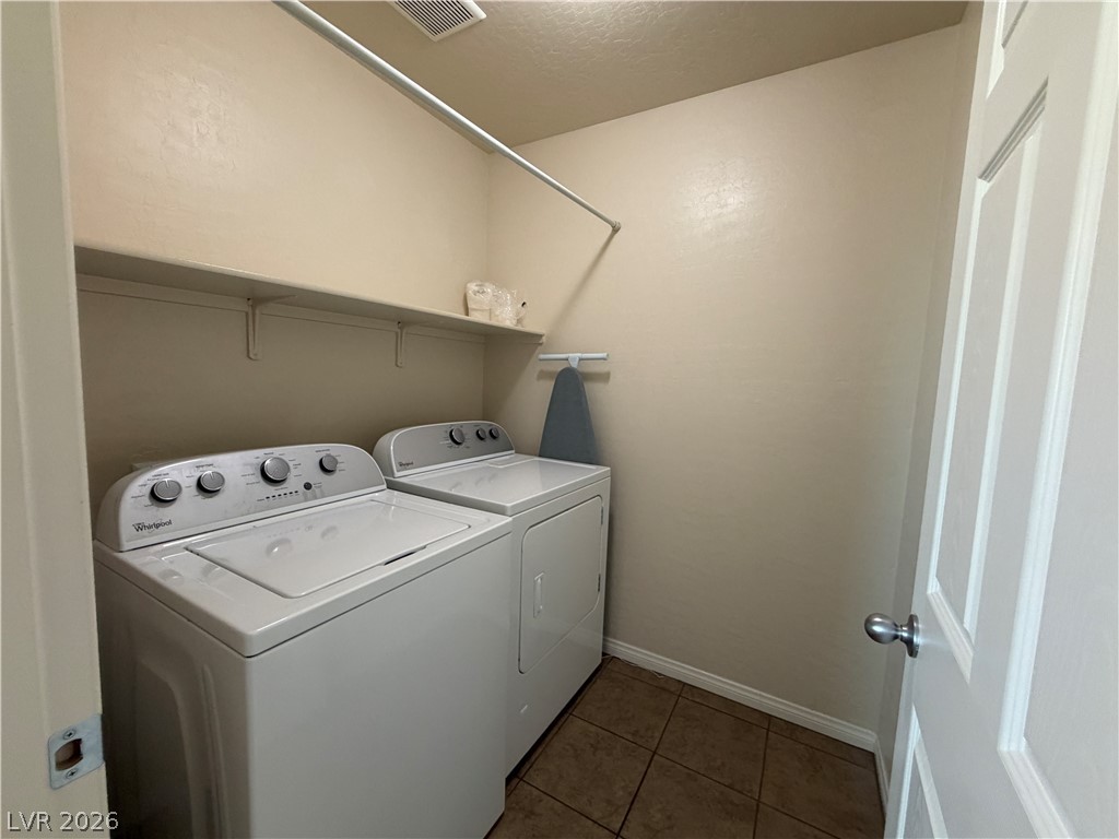 442 White Heart Road Las Vegas, NV 89148 - Photo 9 of 25 Tiled flooring and built-in shelving maximize organization within this dedicated laundry space.
