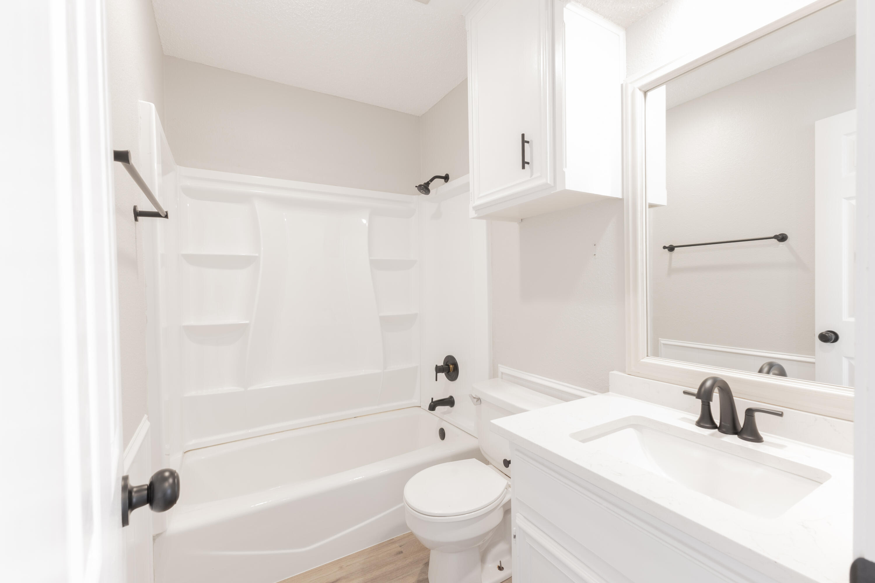 6036 71st Street Lubbock, TX 79424 - Photo 12 of 15 a bathroom with a sink toilet tub and shower