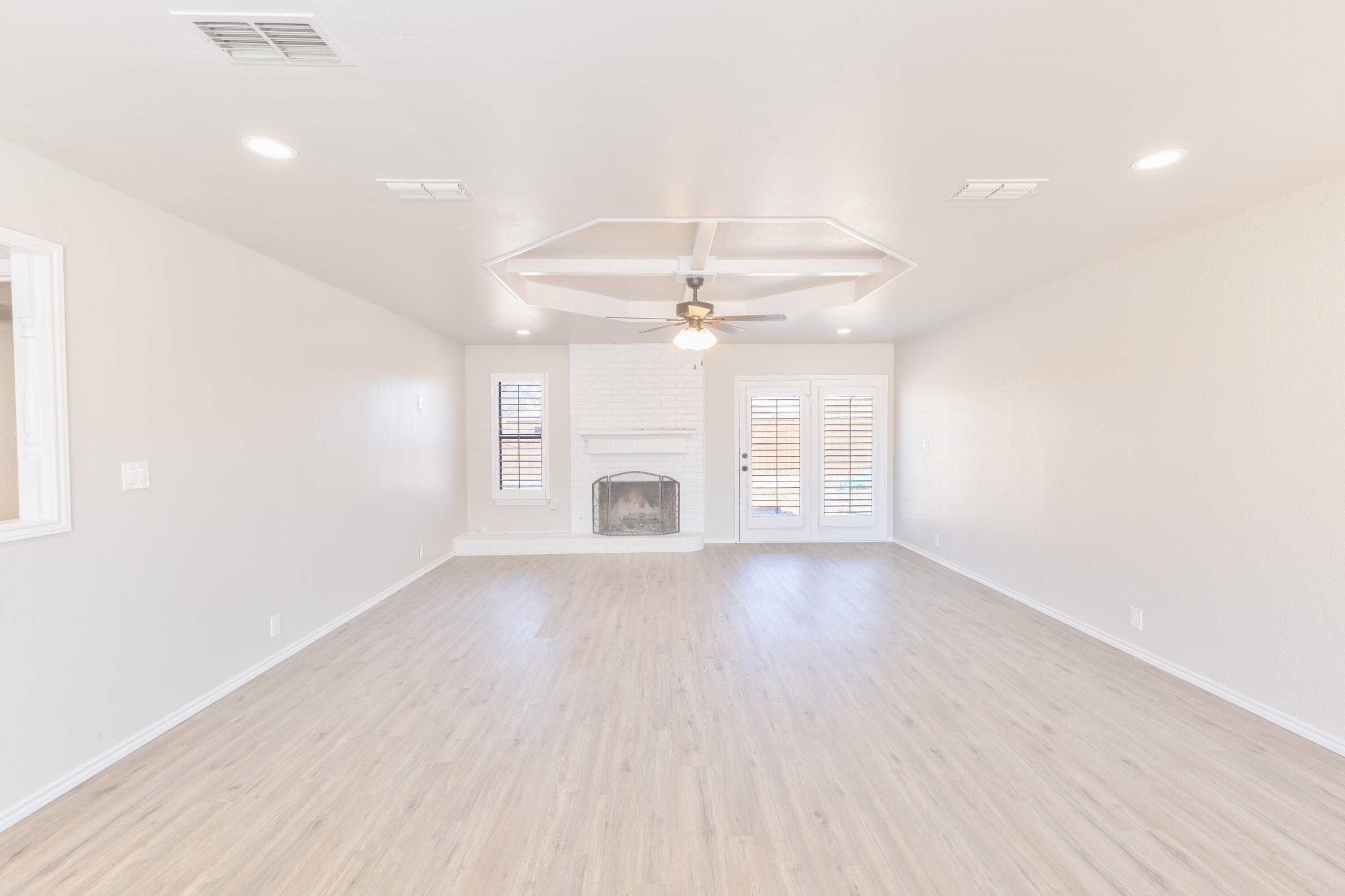 6036 71st Street Lubbock, TX 79424 - Photo 3 of 15 wooden floor in an empty room with a window