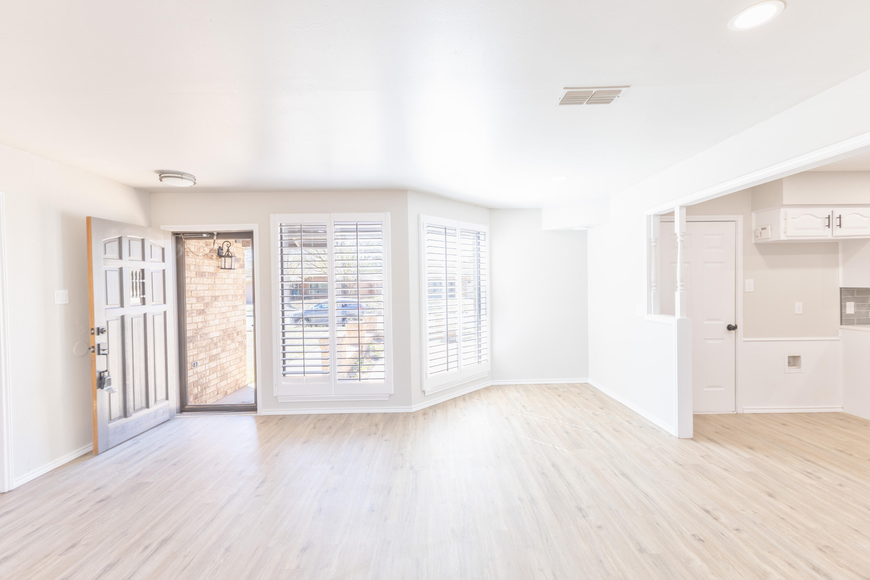 6036 71st Street Lubbock, TX 79424 - Photo 4 of 15 an empty room with wooden floor and windows