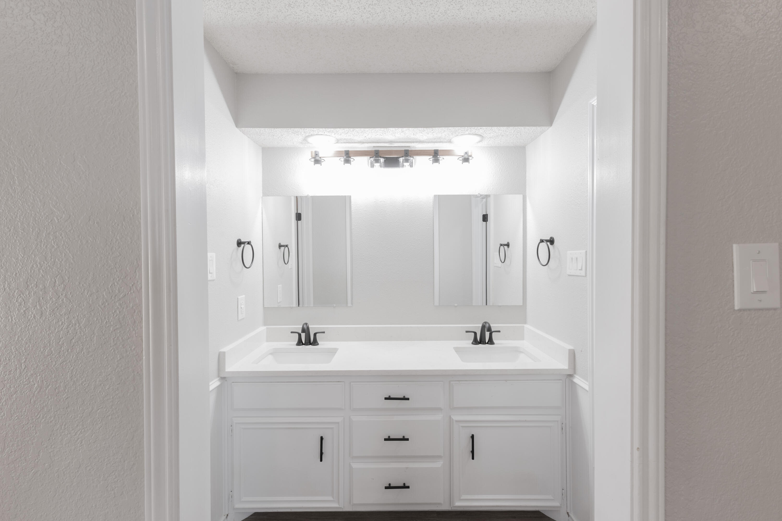6036 71st Street Lubbock, TX 79424 - Photo 8 of 15 a bathroom with a sink mirror and a shower