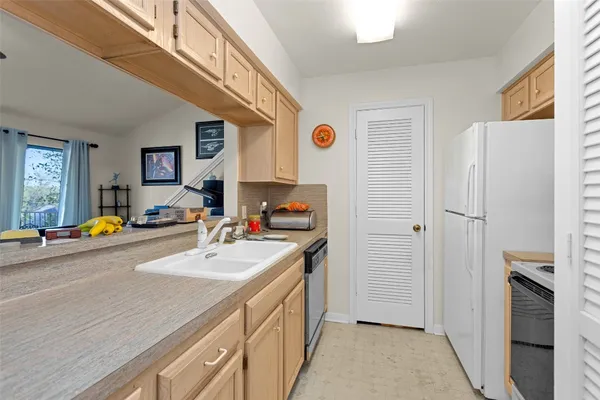 a kitchen with a sink appliances and cabinets