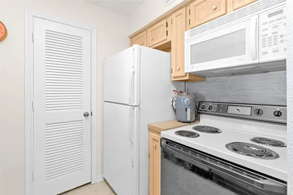a kitchen with a stove and a refrigerator
