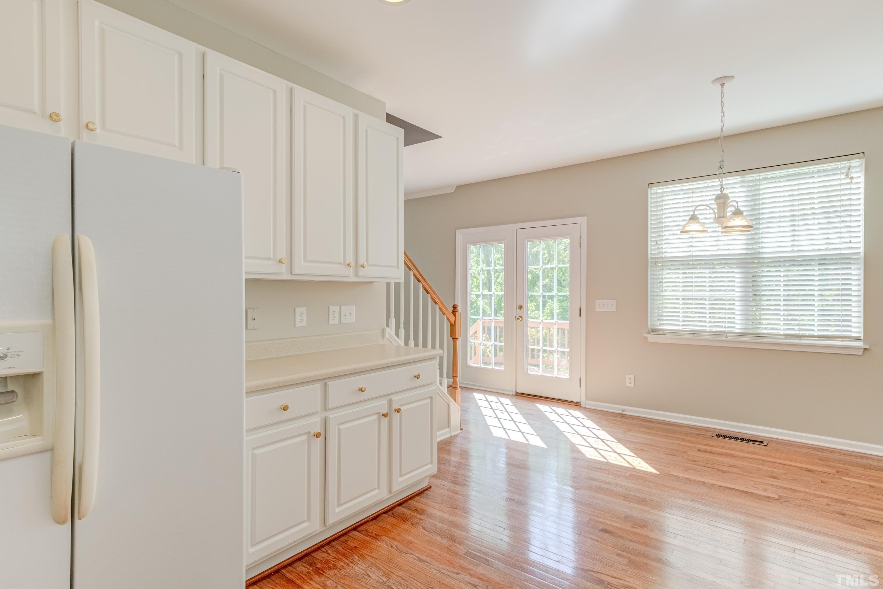 2408 Spruce Shadows Lane Raleigh, NC 27614 - Photo 18 of 40 a view of an empty room with wooden floor and a window