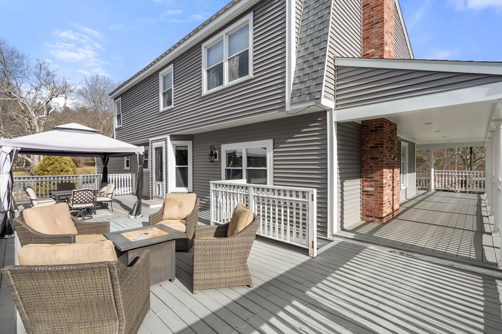 51 Albee Road Uxbridge, MA 01569 - Photo 11 of 42 a view of a dinning tables and chairs in patio of the house