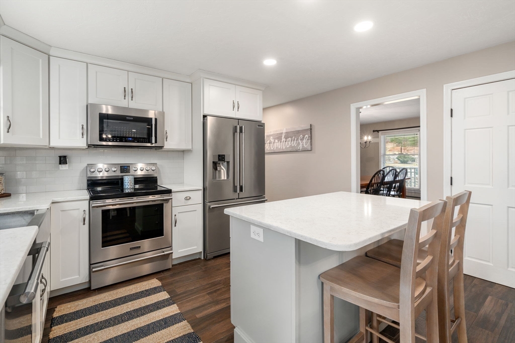 51 Albee Road Uxbridge, MA 01569 - Photo 14 of 42 a kitchen with refrigerator cabinets and wooden floor