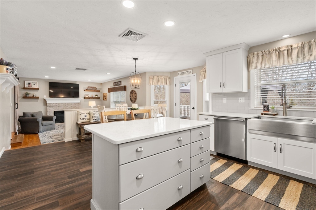 51 Albee Road Uxbridge, MA 01569 - Photo 15 of 42 a kitchen with a sink stainless steel appliances white cabinets and wooden floor