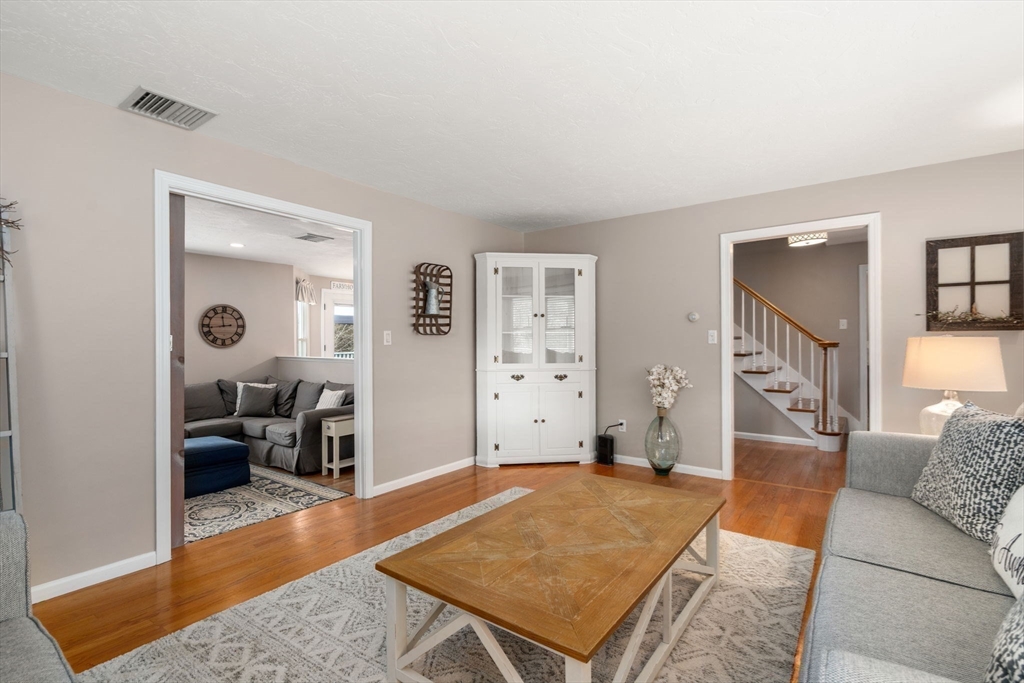51 Albee Road Uxbridge, MA 01569 - Photo 27 of 42 a living room with furniture and a wooden floor
