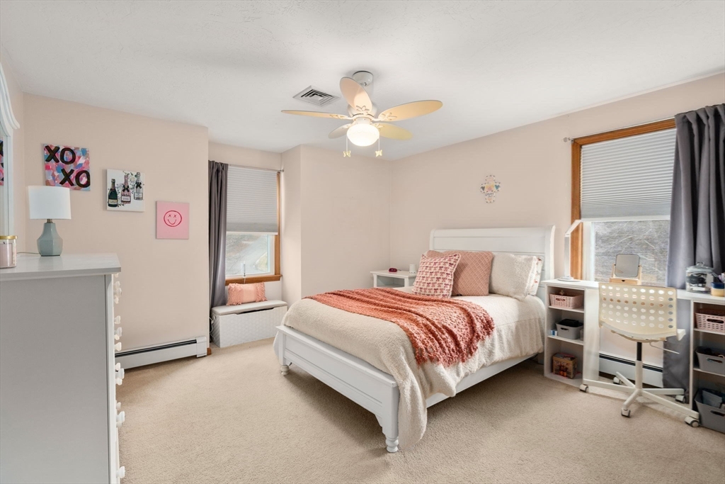 51 Albee Road Uxbridge, MA 01569 - Photo 29 of 42 a bedroom with a bed and a chandelier