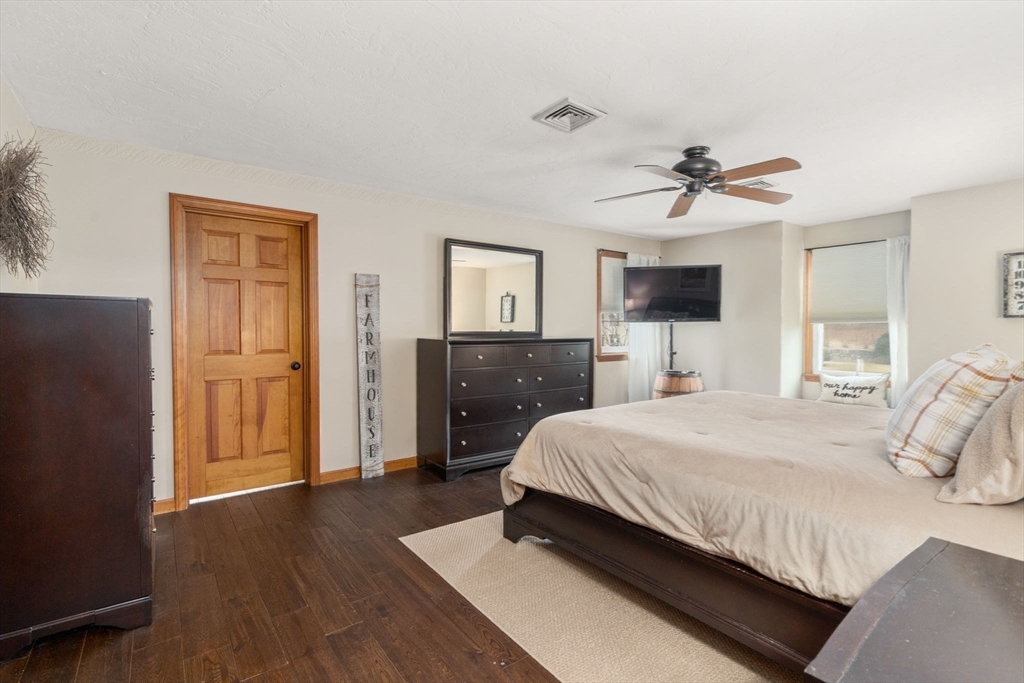 51 Albee Road Uxbridge, MA 01569 - Photo 31 of 42 a spacious bedroom with a bed and wooden floor