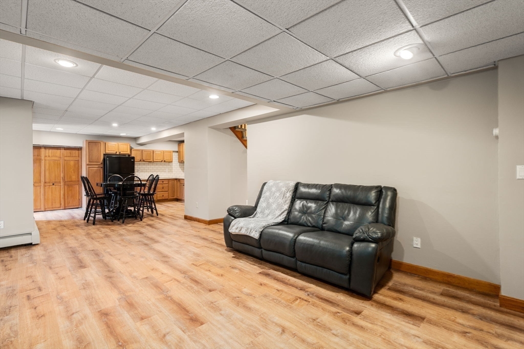 51 Albee Road Uxbridge, MA 01569 - Photo 38 of 42 a living room with furniture and a wooden floor