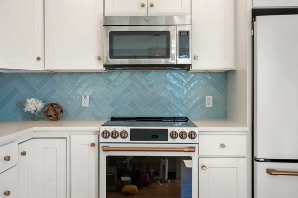 a stove top oven sitting inside of a kitchen
