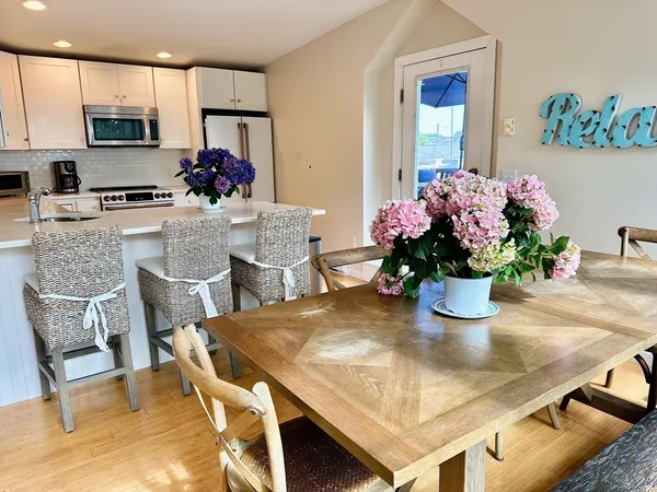a dining room with furniture and flowers