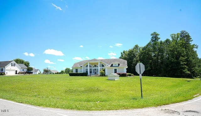 a view of living room kitchen with granite countertop stainless steel appliances cabinets and a counter top space