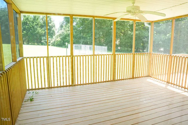a view of a room with wooden floor and windows