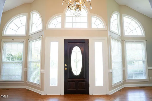 a view of a room with wooden floor and white walls
