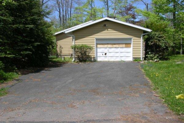 1156 Pine Tree Road Tobyhanna, PA 18466 - Photo 2 of 4 a front view of a house with yard and green space