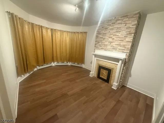 a view of an empty room with a fireplace