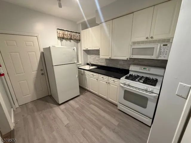 a kitchen with a refrigerator sink and stove
