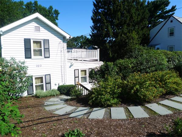 323 Appleton Street Arlington, MA 02476 - Photo 2 of 9 a view of a white house with a yard and large tree